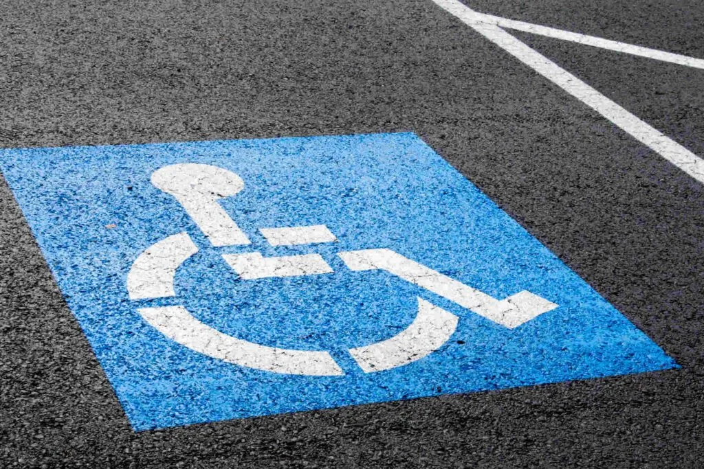 handicap parking sign painted on parking space