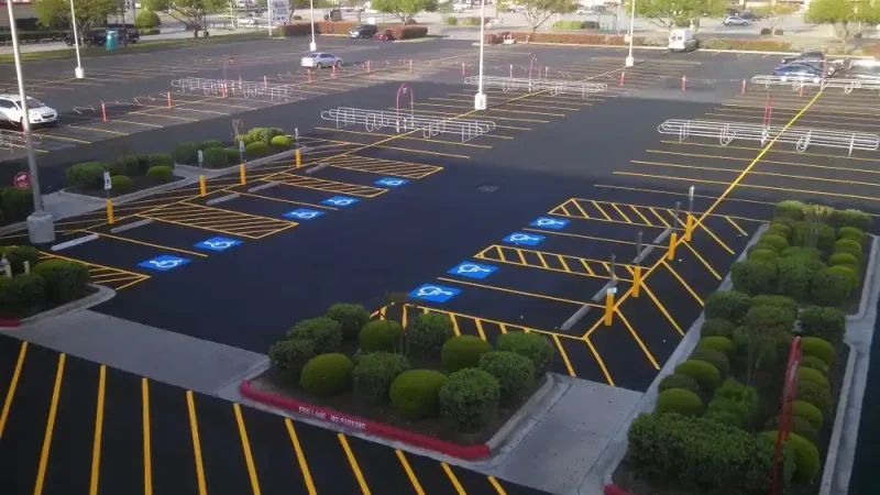The Ultimate Guide to Parking Lot Maintenance in Kansas City - Kansas Asphalt aerial view of empty parking lot