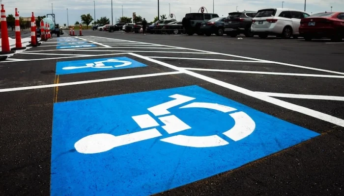 ADA Compliant signage painted on pavement in parking lot