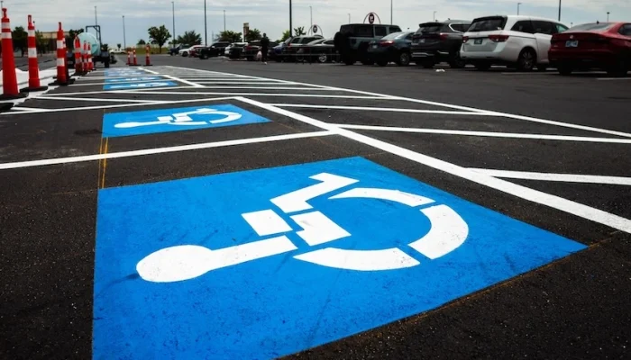 ADA Compliant signage painted on pavement in parking lot